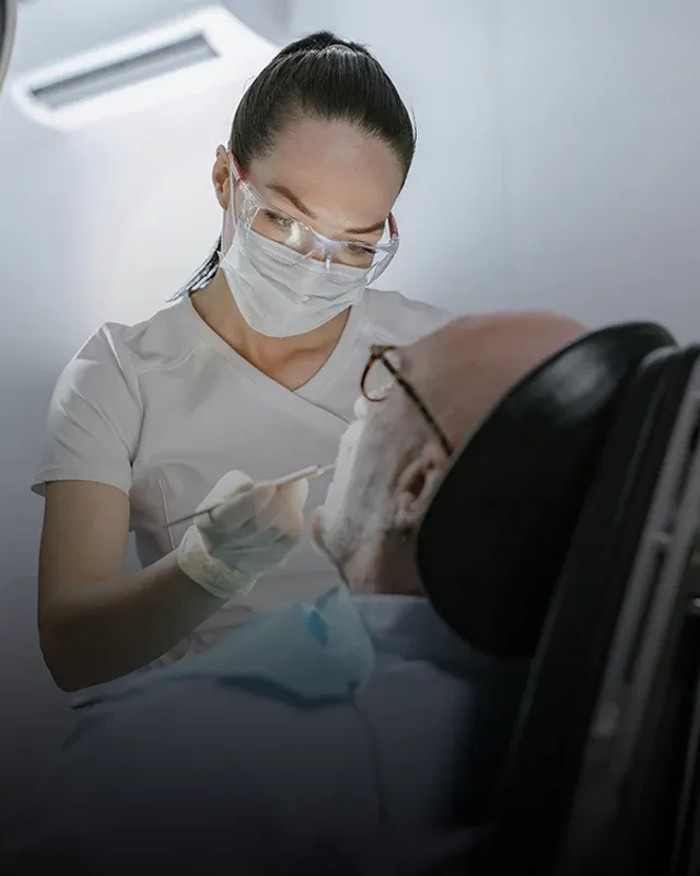 A dental professional cleaning a patient's teeth